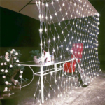 LED net mesh string lights spread on outdoor greenery