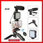 AY-49 Vlogger Kit components laid out showing microphone, LED light, tripod, and remote