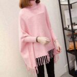 Pink fleece poncho draped on model showing soft warm fabric