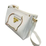 white handbag with metallic cat-shaped handle front view