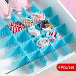 Four-piece adjustable drawer organizer set arranged on wooden surface