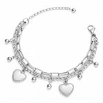 Close-up of stainless steel hearts bracelet on wrist