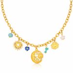 Close-up of 18K gold plated crescent and sun necklace on white background