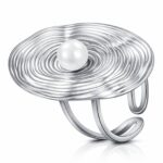 Adjustable stainless steel ring with imitation pearl on white background