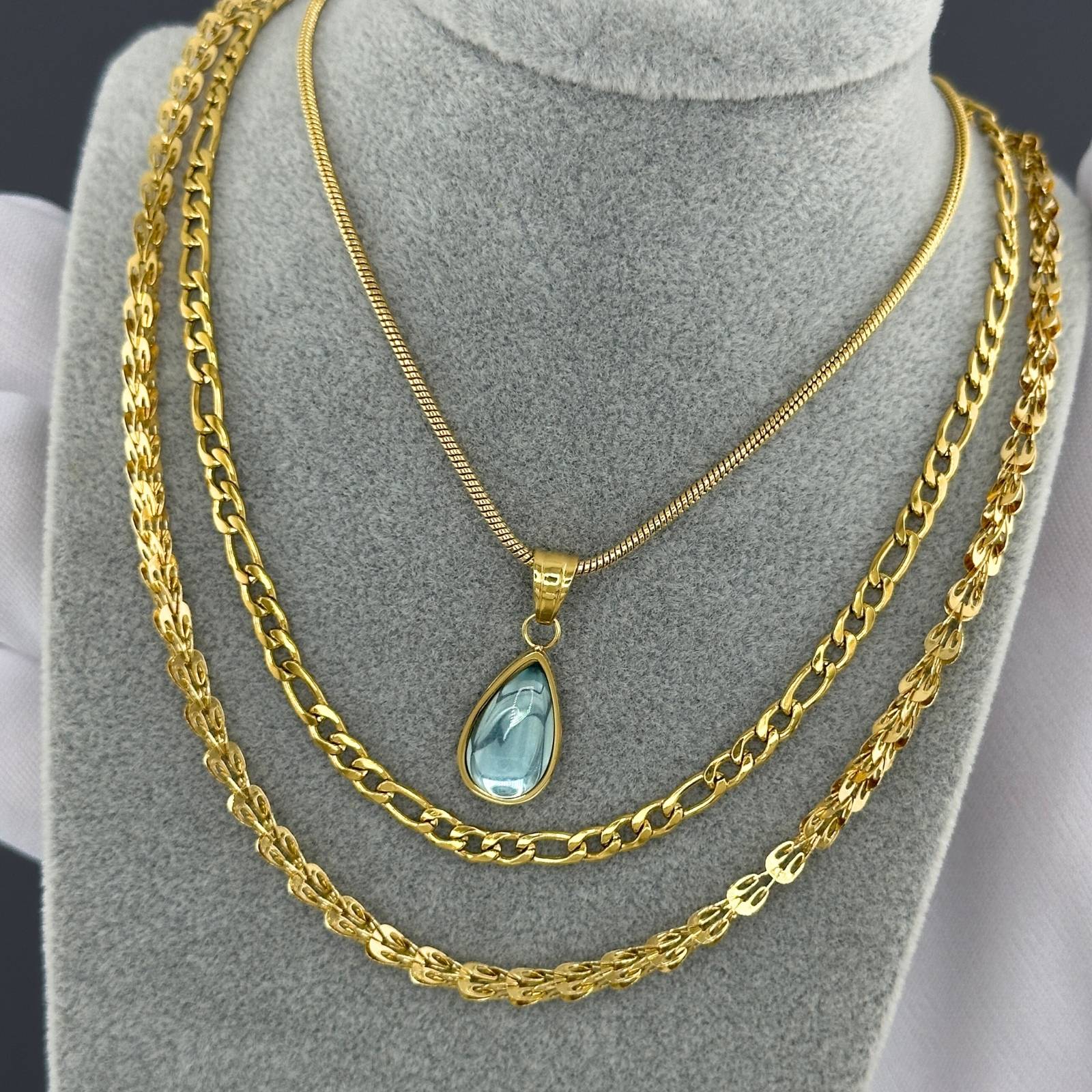 Close-up of lobster claw clasp on gold plated necklace