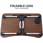 Foldable brown laptop table with tablet groove and cup holder on wooden floor