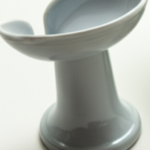Ceramic elevated soap holder with curved design on countertop