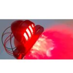 Vintage cafe racer brake and tail light with number plate holder on black background