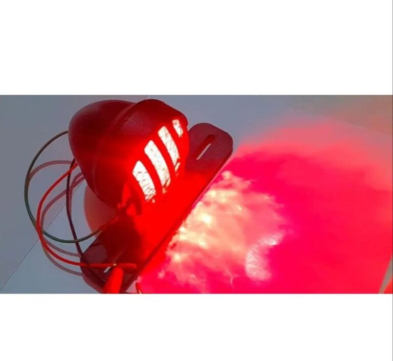 Vintage cafe racer brake and tail light with number plate holder on black background