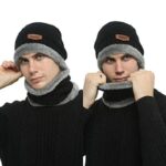 Black and gray wool beanie and neck warmer set on white background