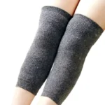 Unisex wool knee warmers in black displayed folded