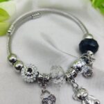 Imported silver charm bracelet with heart lock and teddy bear accents