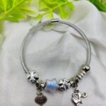 Elegant Pandora-style charm bracelet with opalescent star bead and silver charms
