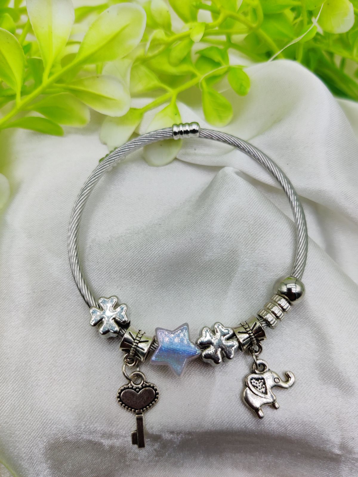 WhatsApp-Image-2025-02-04-at-4.30.05-PM.jpeg Elegant Pandora-style charm bracelet with opalescent star bead and silver charms