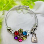 Imported multicolor stone charm bracelet with flower centerpiece and clover lock charms
