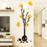 Golden and black acrylic mirror rabbit vase wall art on white wall