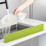 Large silicone sink splash guard on kitchen sink edge