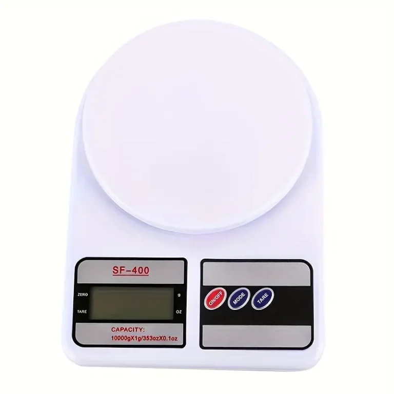 Digital kitchen scale on a white countertop displaying 0g on backlit LCD