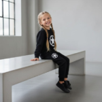 Kids black fleece tracksuit with star print front view